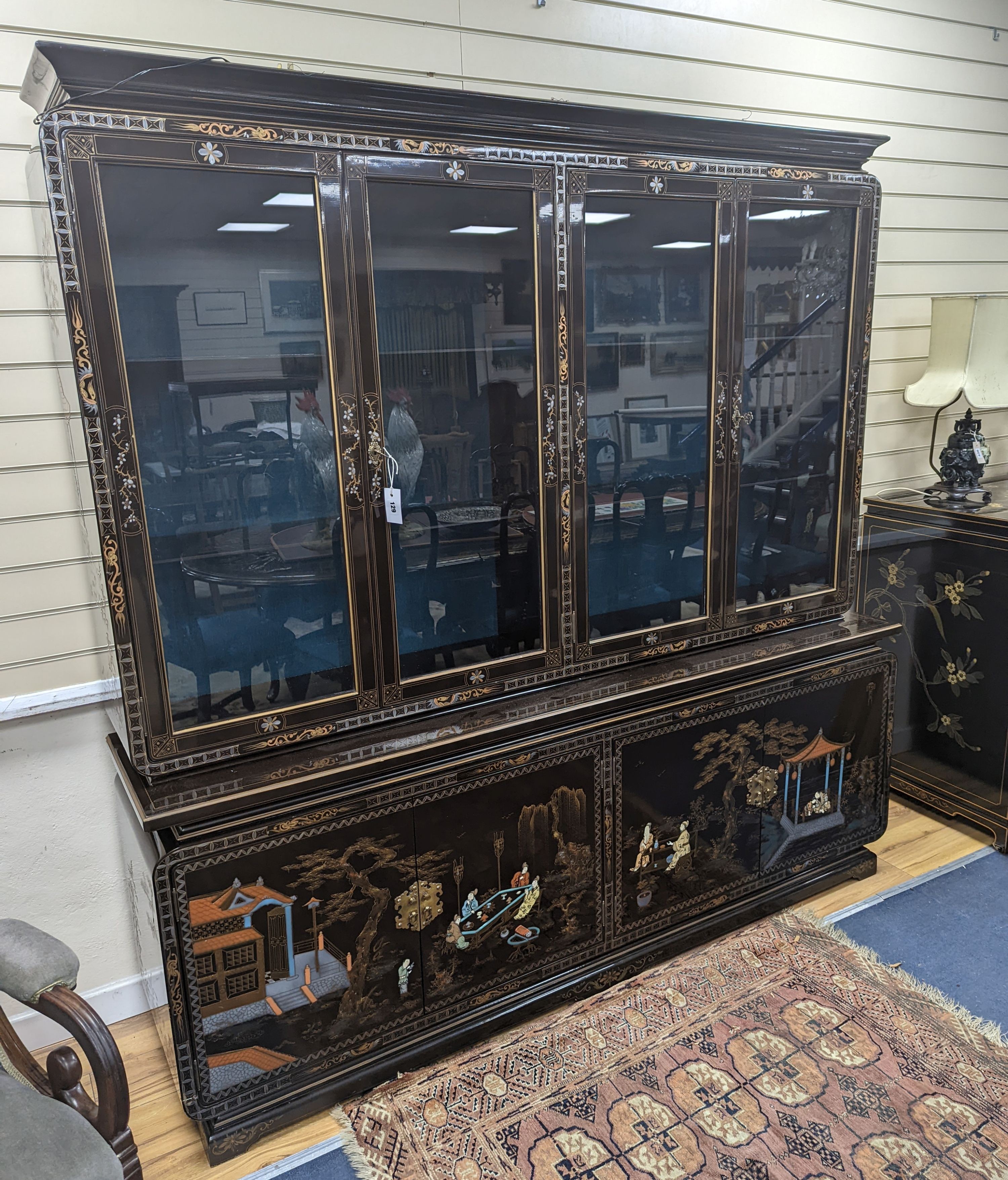 A Chinese lacquer decorated cabinet. W-200cm, D-45cm, H-201cm.